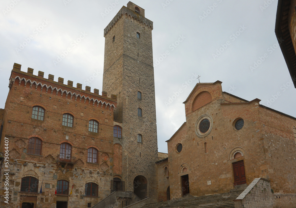 Town hall and church and medieval tower in the ancient village of San Gimignano in the Tuscany region in Italy