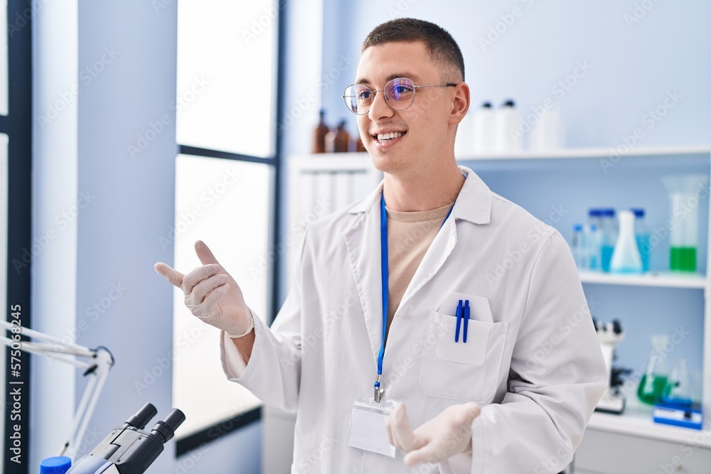 Young hispanic man scientist smiling confident speaking at laboratory Young hispanic man scientist smiling confident speaking at laboratory