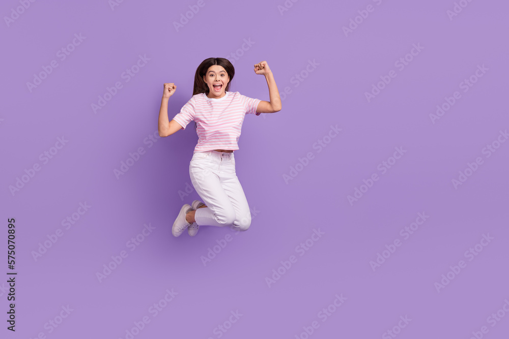 Full body photo of overjoyed cheerful person raise fists success empty space isolated on violet color background