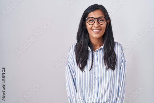 Young hispanic woman wearing glasses with a happy and cool smile on face. lucky person.
