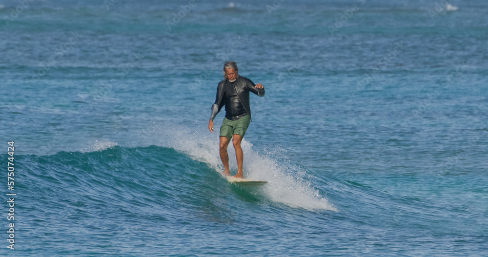 Mature man surfer surfing ocean waves Mature man surfer surfing ocean waves