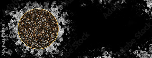 Tin of Caviar on ice on black background on banner format