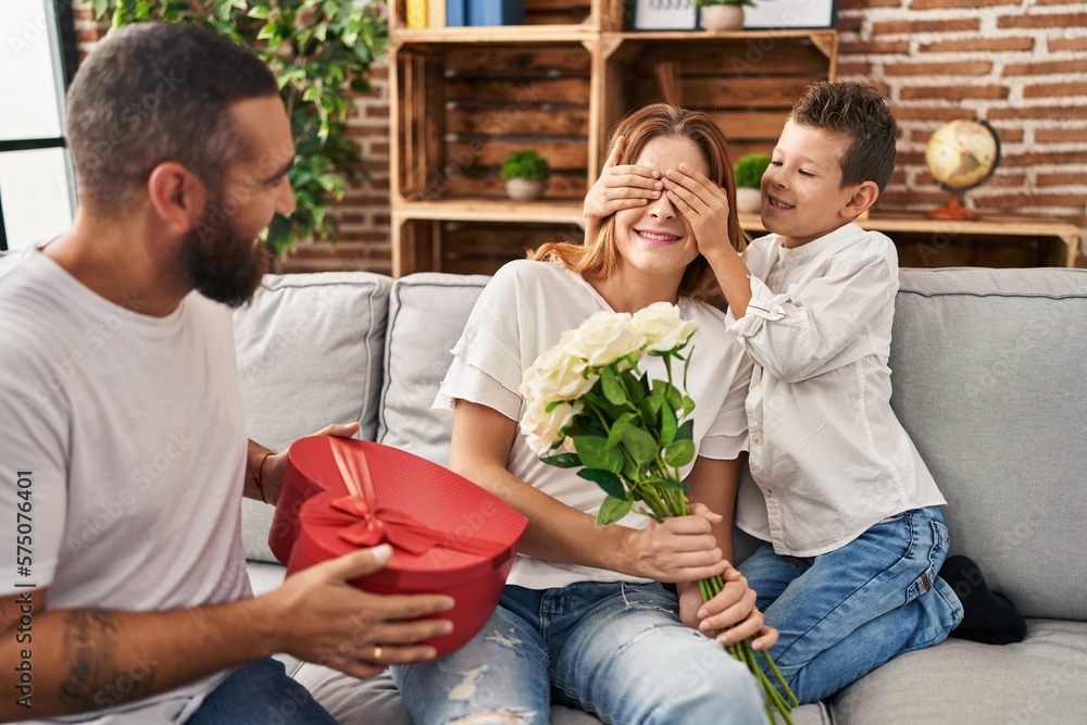 Fototapeta premium Family surprise mother with gift and flowers at home