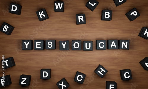 Yes you can. Black dice with white capital letters on a table. Inspiration, encouragement, the way forward and positive emotion. 3D illustration