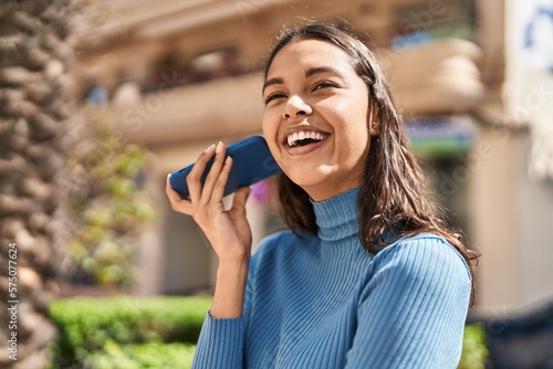 Young african american woman smiling confident listening audio message by the smartphone at street