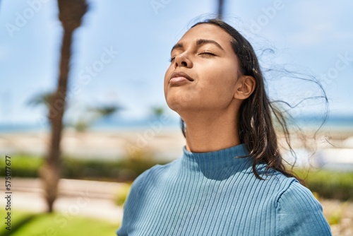 Young african american woman breathing at park photo