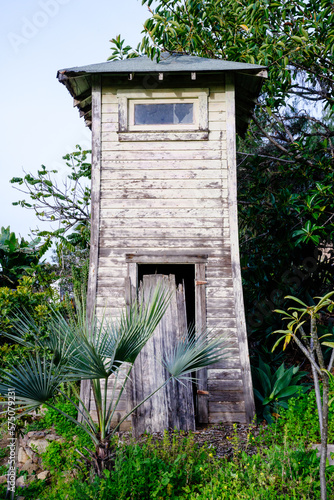 Old wooden well tower with chipping paint