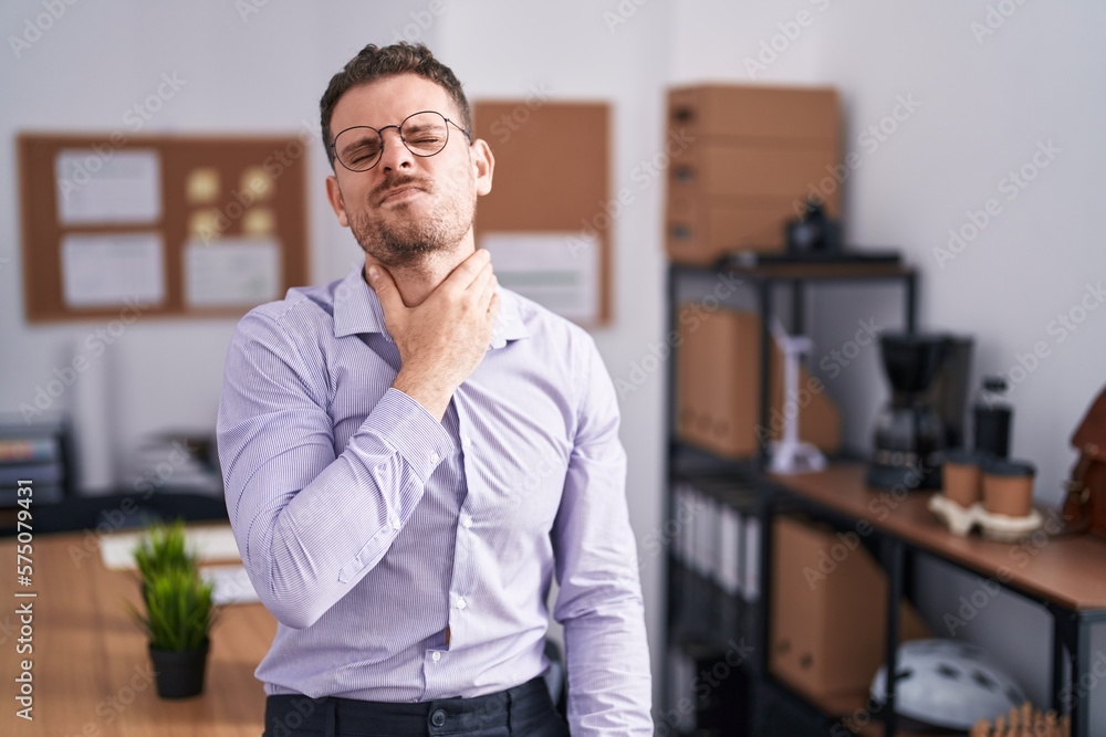 Young hispanic man at the office touching painful neck, sore throat for flu, clod and infection Young hispanic man at the office touching painful neck, sore throat for flu, clod and infection