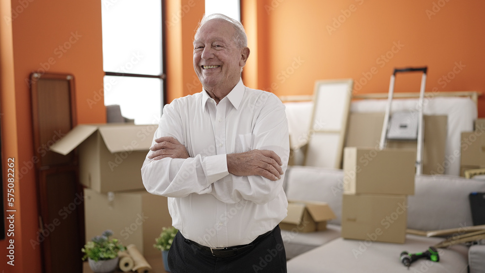 senior smiling confident standing with arms crossed gesture at new home