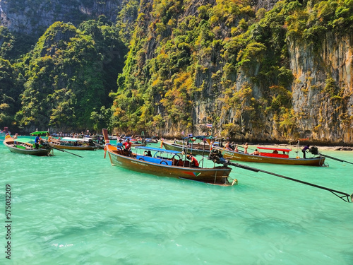 Beautiful blue sea water and boats with tourists in the lagoon of Maya Bay island in Thailand