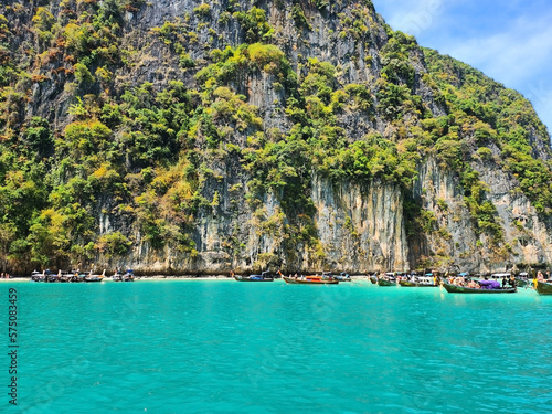 Tourist boats in the blue lagoon on Maya Bai island in Thailand