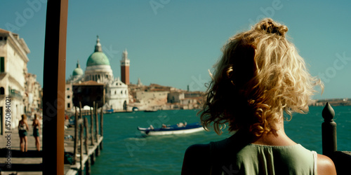 Vertical shot of blonde 30 years old woman looks at speed boat and waters in Venice Italy Generative AI
