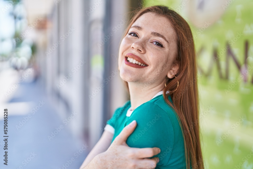 Young redhead woman smiling confident standing at street Young redhead woman smiling confident standing at street