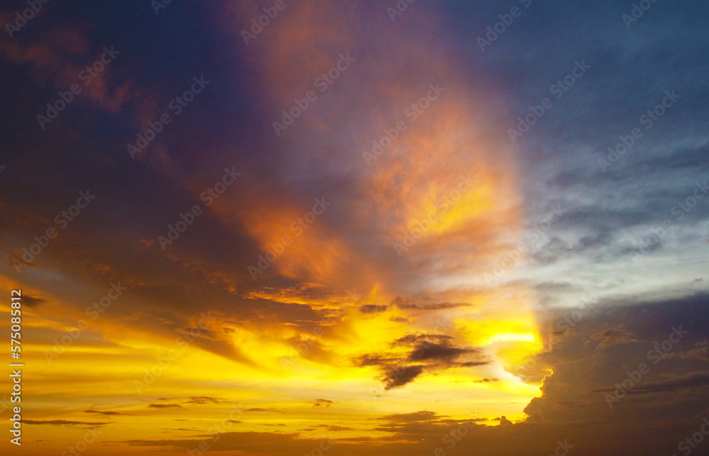 Aerial view of the sunset in an orange sky with clouds. Beautiful background for tourism and advertising. Tropical coast