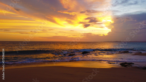 Aerial view of the sunset on the beach on the ocean. Beautiful background for tourism and advertising. Tropical coast © Payllik