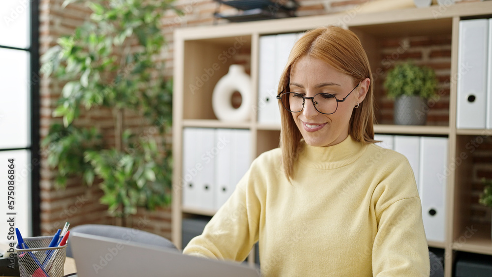 Young blonde woman business worker using laptop working at office Young blonde woman business worker using laptop working at office