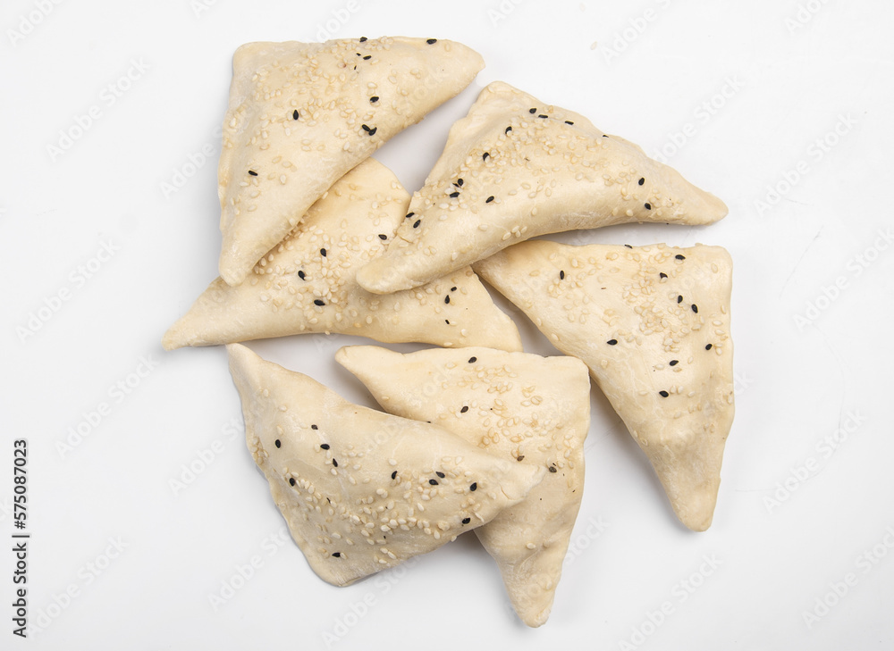 Frozen fresh samsa with black sesame on white background Frozen fresh samsa with black sesame on white background