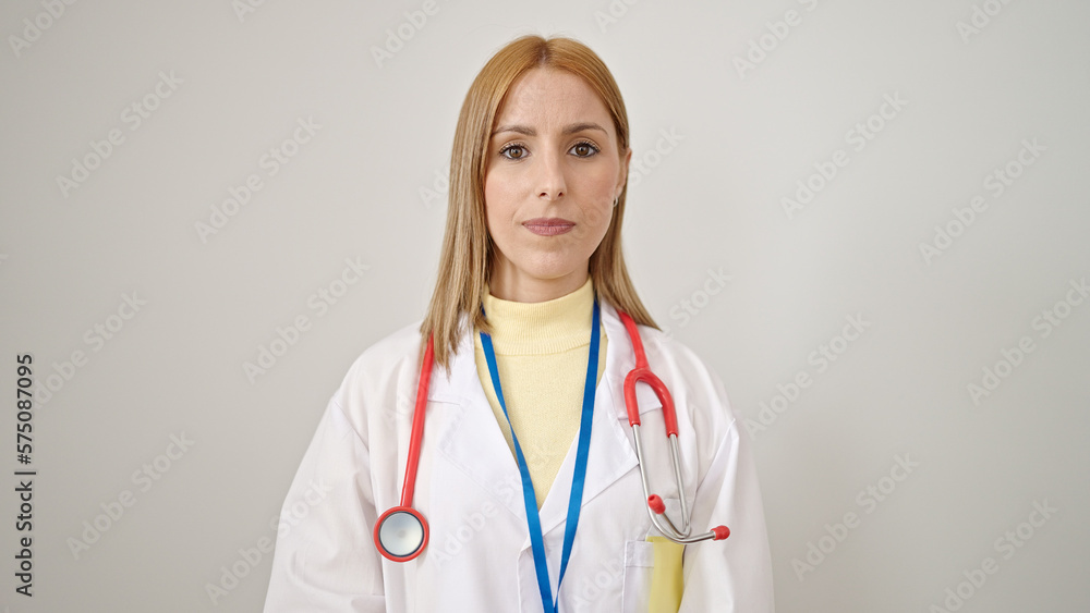 Young blonde woman doctor smiling confident standing over isolated white background Young blonde woman doctor smiling confident standing over isolated white background