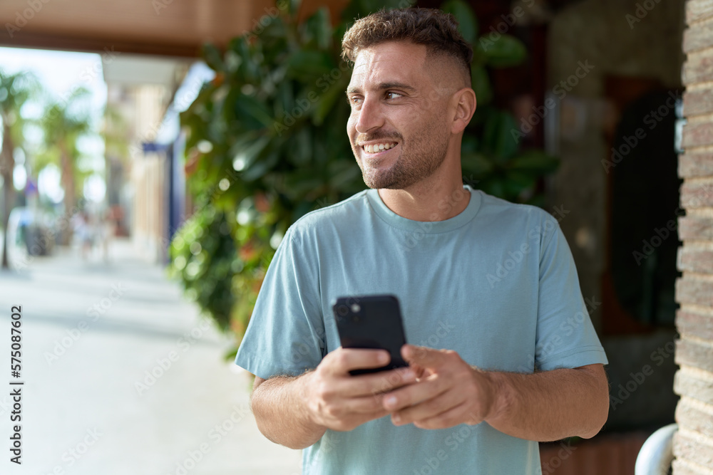 Young hispanic man smiling confident using smartphone at street Young hispanic man smiling confident using smartphone at street