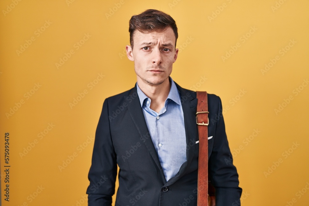 Caucasian business man over yellow background depressed and worry for distress, crying angry and afraid. sad expression. Caucasian business man over yellow background depressed and worry for distress, crying angry and afraid. sad expression.