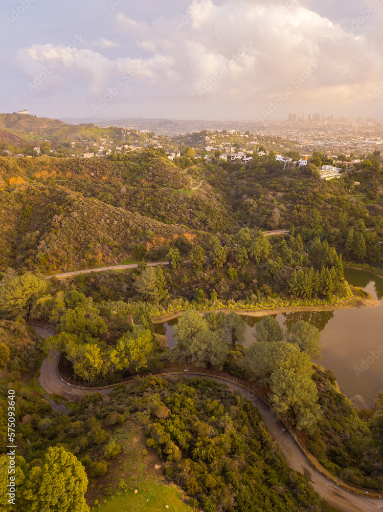 High-angle views taken from a drone of Lake Hollywood, or Hollywood Reservoir, in the Hollywood neighborhood of Los Angeles, California. Pictures taken after a large rainfall showing the lush foliage.
