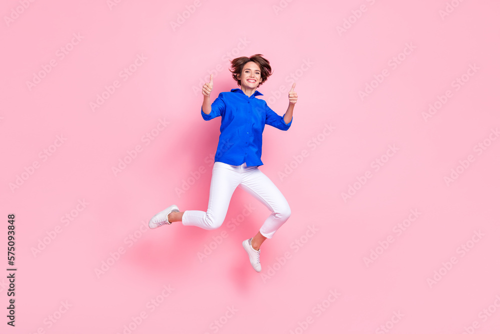 Full body size cadre of young jumping overjoyed entrepreneur business woman thumbs up enjoy new her new job isolated on pink color background Full body size cadre of young jumping overjoyed entrepreneur business woman thumbs up enjoy new her new job isolated on pink color background