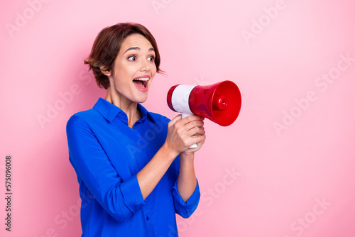 Tableau sur toile Portrait of positive overjoyed girl hands hold loudspeaker look speak talk empty