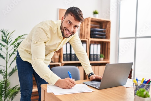 Young hispanic man business worker working at office