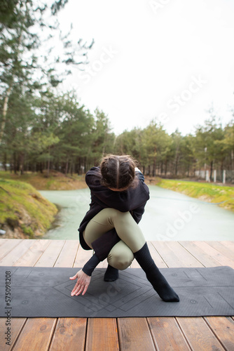 young woman doing yoga in nature