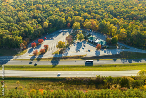 Aerial view of big rest area near busy american freeway with fast moving cars and trucks. Recreational place during interstate travel concept