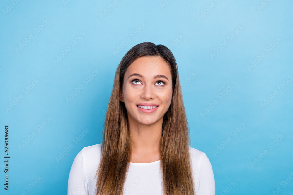 Photo of adorable lovely cheerful lady wear white clothes interested look empty space profitable offer isolated on blue color background Photo of adorable lovely cheerful lady wear white clothes interested look empty space profitable offer isolated on blue color background