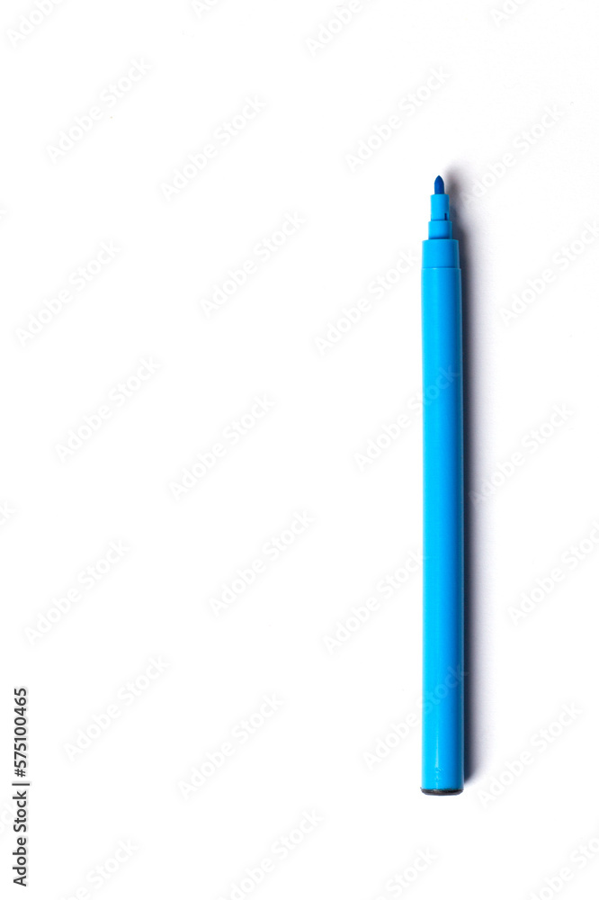 A blue felt-tip pen with a cap lies on a white background. empty space for writing A blue felt-tip pen with a cap lies on a white background. empty space for writing
