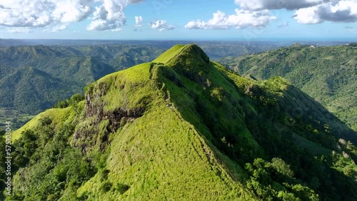Flying over a Puerto Rican mountain ridge with people on top.