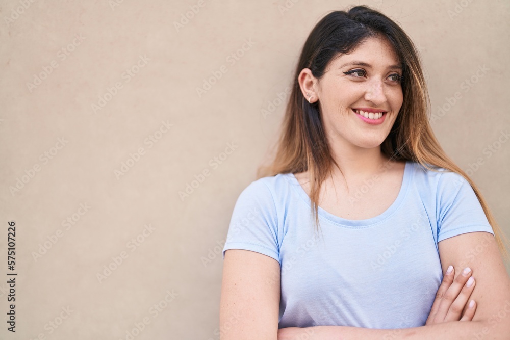 Young hispanic woman smiling confident standing with arms crossed gesture over isolated white background Young hispanic woman smiling confident standing with arms crossed gesture over isolated white background