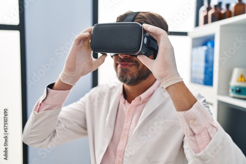Middle age man scientist using virtual reality glasses at laboratory