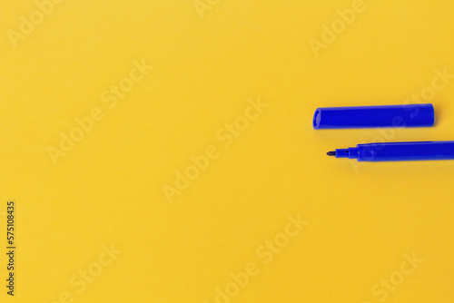 Blue marker with cap. On a yellow background. Empty space for an inscription.