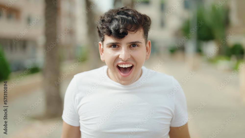 Non binary man standing with surprise expression at park Non binary man standing with surprise expression at park