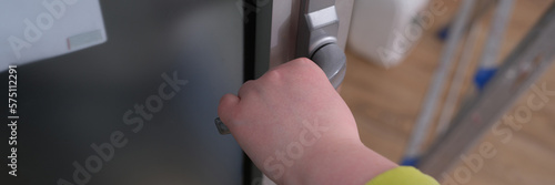 Closeup of woman hand holding and pushing doorknob