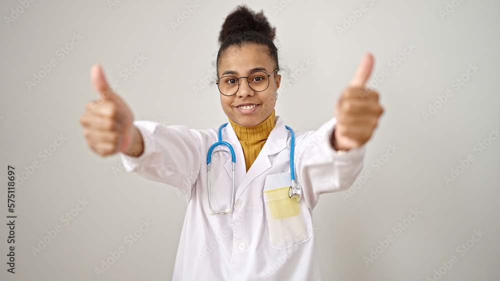 Young african american woman doctor doing thumbs up over isolated white background Young african american woman doctor doing thumbs up over isolated white background