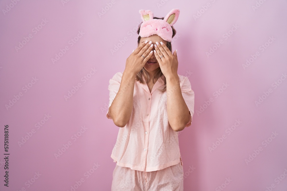 Blonde caucasian woman wearing sleep mask and pajama rubbing eyes for fatigue and headache, sleepy and tired expression. vision problem