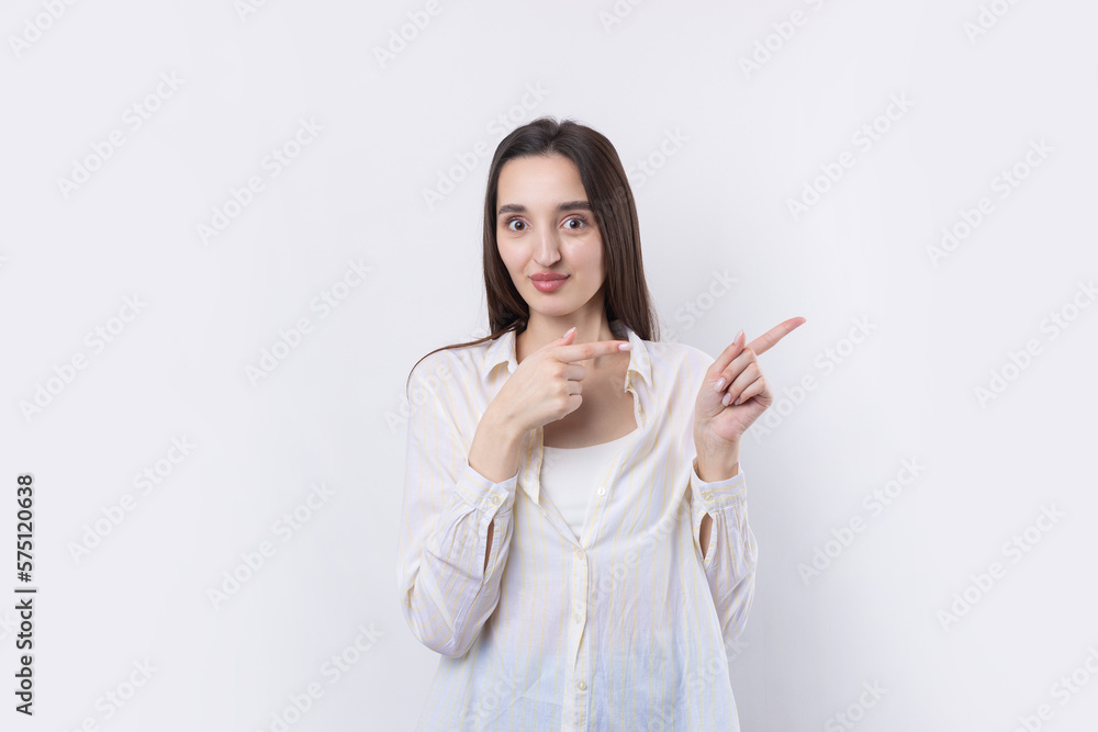 Happy young caucasian female in a shirt pointing fingers away Happy young caucasian female in a shirt pointing fingers away