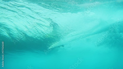 Tourist Surfing Seen From Wavy Underwater During Adventurous Vacation - Thulusdhoo, Maldives photo