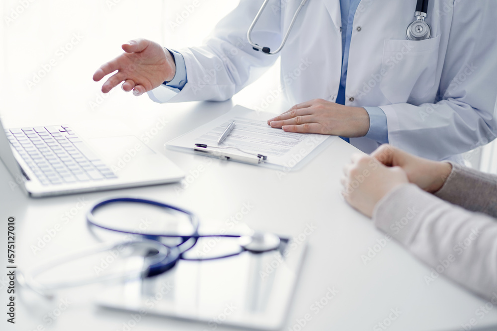 Doctor and patient discussing current health questions while sitting at the table in clinic office, only hands closeup. Medicine concept Doctor and patient discussing current health questions while sitting at the table in clinic office, only hands closeup. Medicine concept