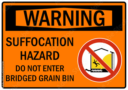 Grain bin hazard sign and labels suffocation hazard. Do not enter bridged grain silo