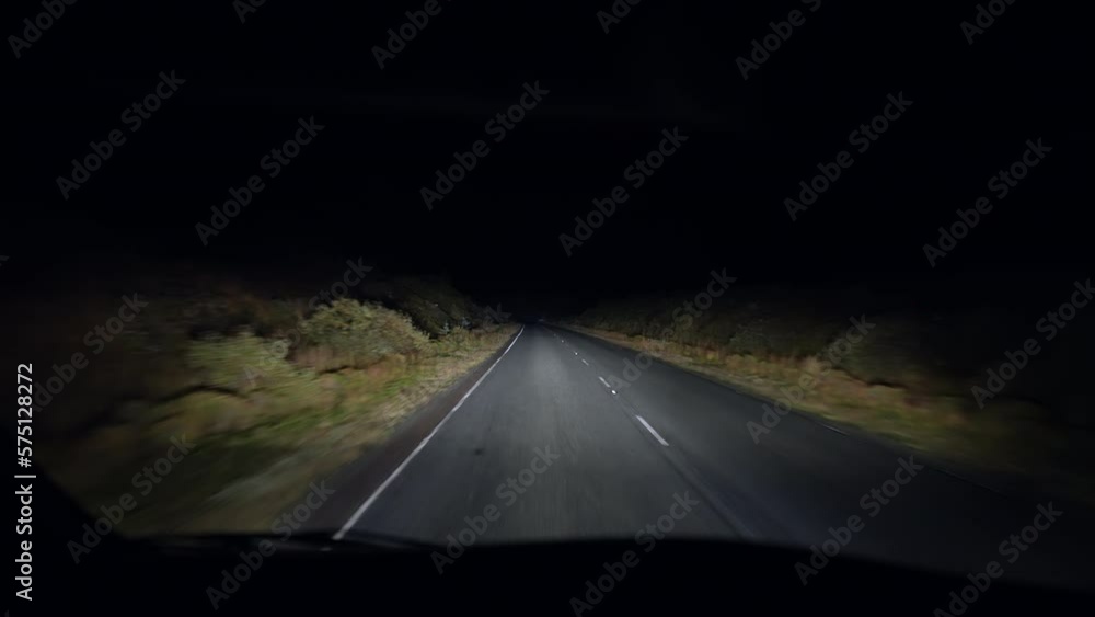 Driver perspective at night in the dark. Person point of view driving on empty road in countryside