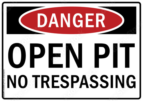 Open pit hazard sign and labels no trespassing