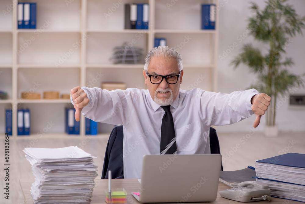 Old male employee working in the office Old male employee working in the office