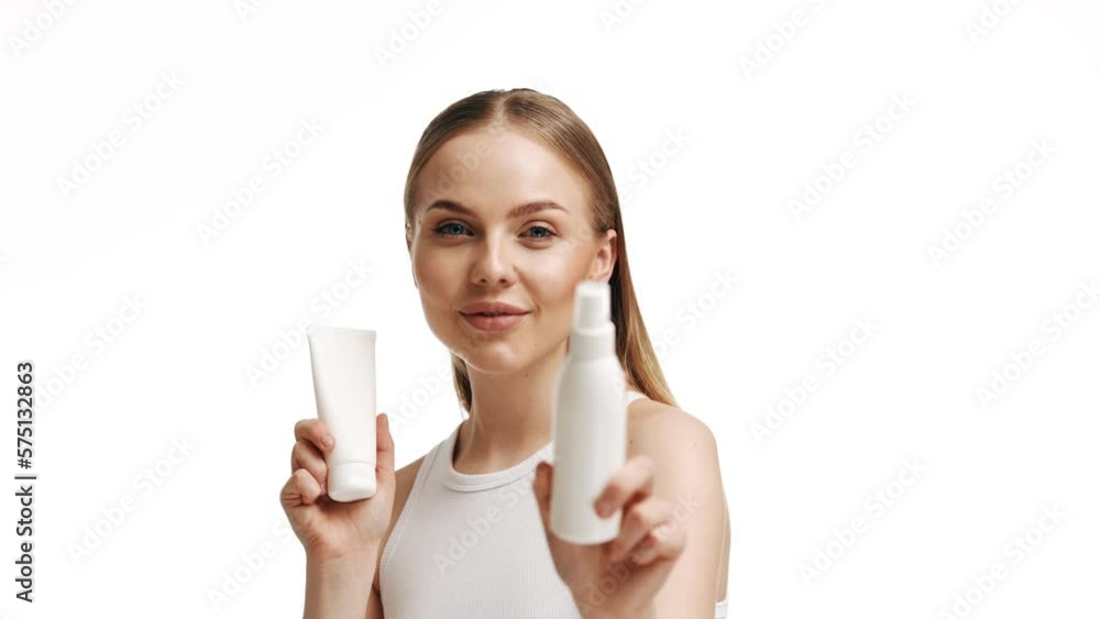 Beautiful blonde girl with a bottle of shampoos in hands. Girl with shiny and long hair. Woman long hair. Woman hold bottle shampoo and conditioner. Woman holding shampoo bottle Beautiful blonde girl with a bottle of shampoos in hands. Girl with shiny and long hair. Woman long hair. Woman hold bottle shampoo and conditioner. Woman holding shampoo bottle
