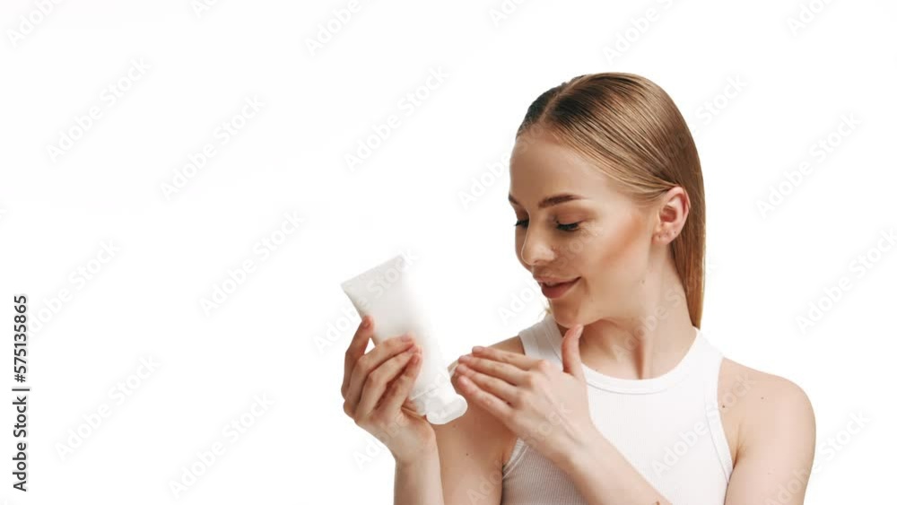 Close Up Beautiful Young Caucasian Blonde Woman With Blue Eyes And Smooth Healthy Skin Holding A Container Of Cream And Using White Cream Skin Care Cosmetic Concept Close Up Beautiful Young Caucasian Blonde Woman With Blue Eyes And Smooth Healthy Skin Holding A Container Of Cream And Using White Cream Skin Care Cosmetic Concept