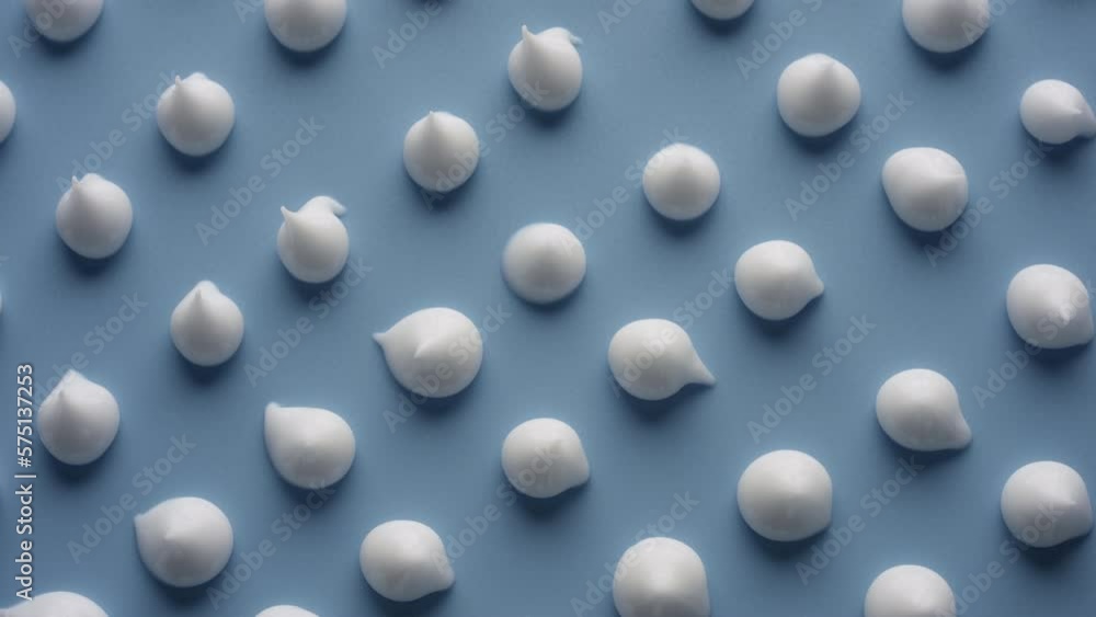 Extreme close-up jib shot of multiple drops of white cream on pale blue background being in the shadow | Cosmetic cream advertising Extreme close-up jib shot of multiple drops of white cream on pale blue background being in the shadow | Cosmetic cream advertising